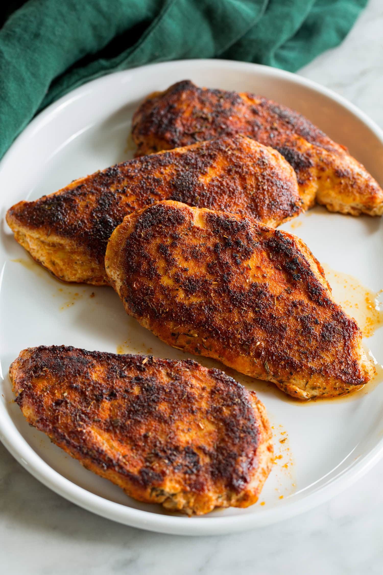 Four pieces of blackened chicken breasts plain. 