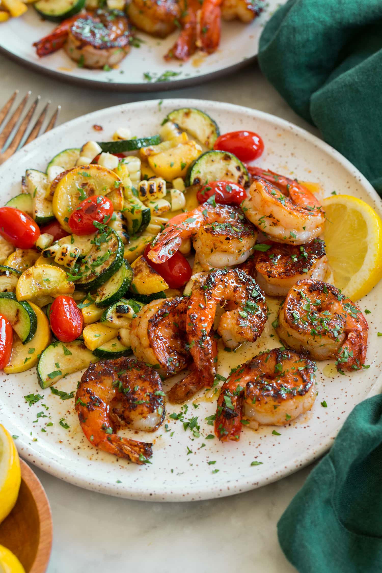 Shrimp with serving suggestion of zucchini, squash, corn and tomatoes.