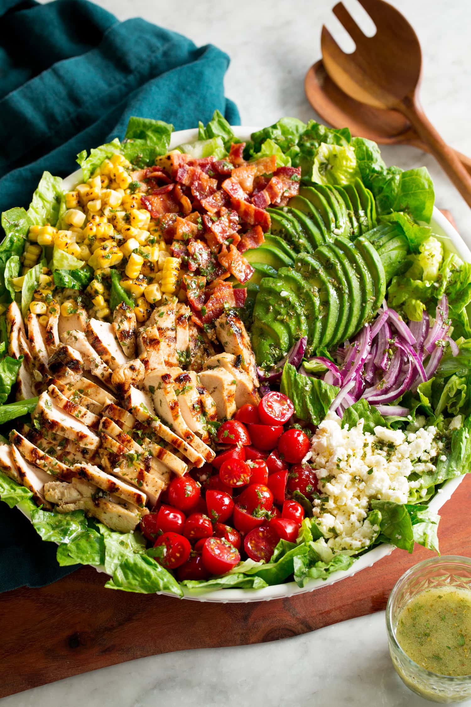 Grilled chicken salad with chicken, bacon, tomatoes, corn, avocado, romaine, red onion and feta.