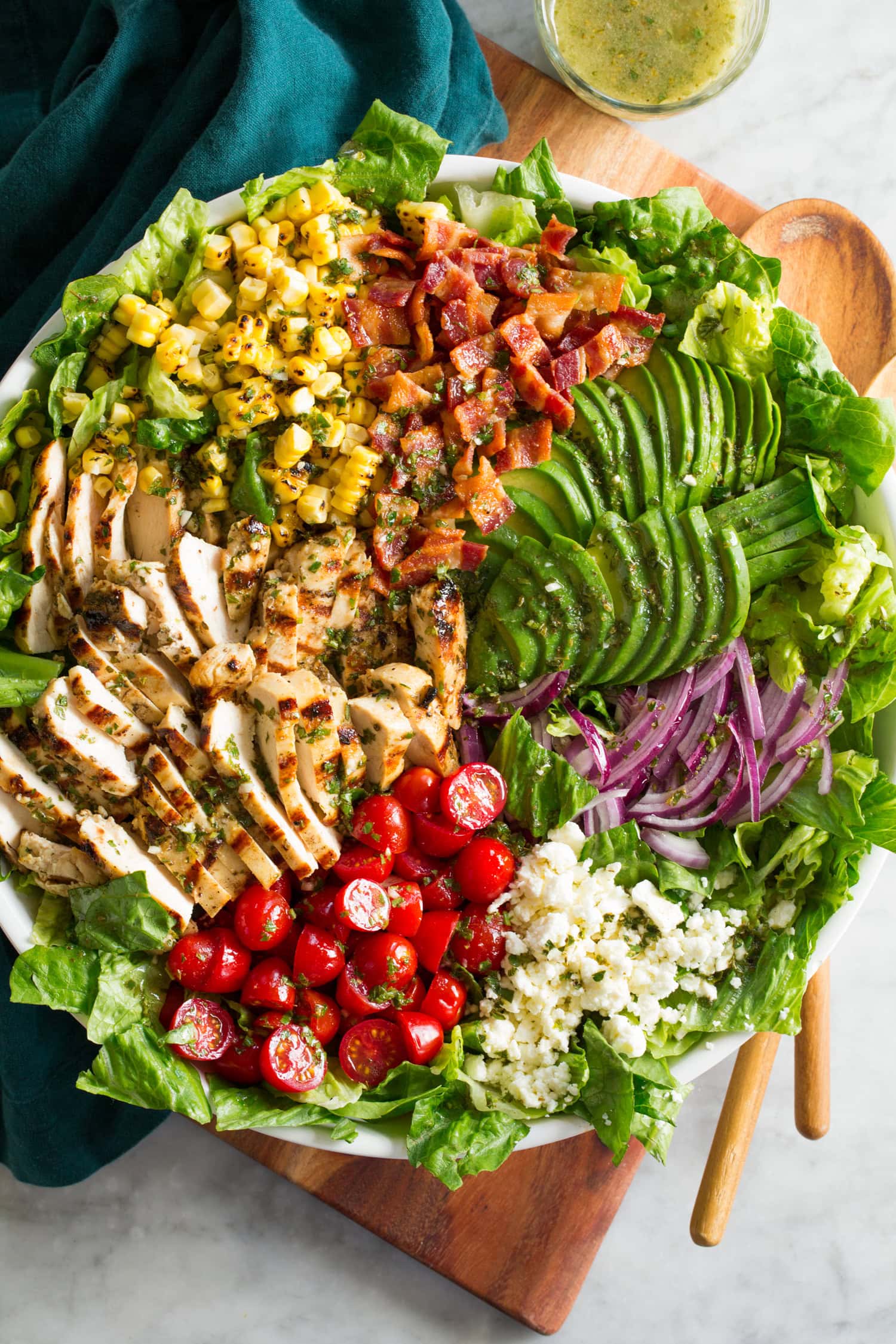 Overhead photo of colorful grilled chicken salad with summery vegetables.