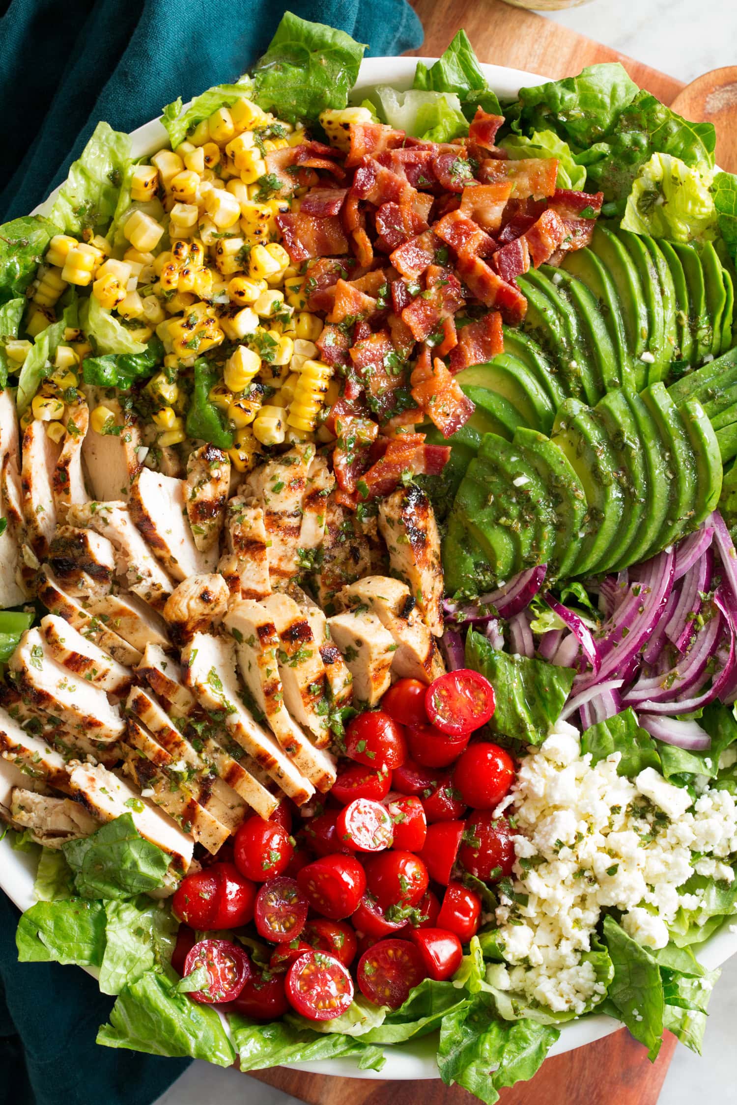 Close up photo of grilled chicken salad showing various ingredient textures and colors.