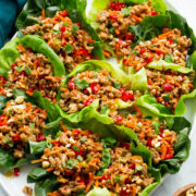 Thai chicken lettuce shown assembled close together on a white oval platter.