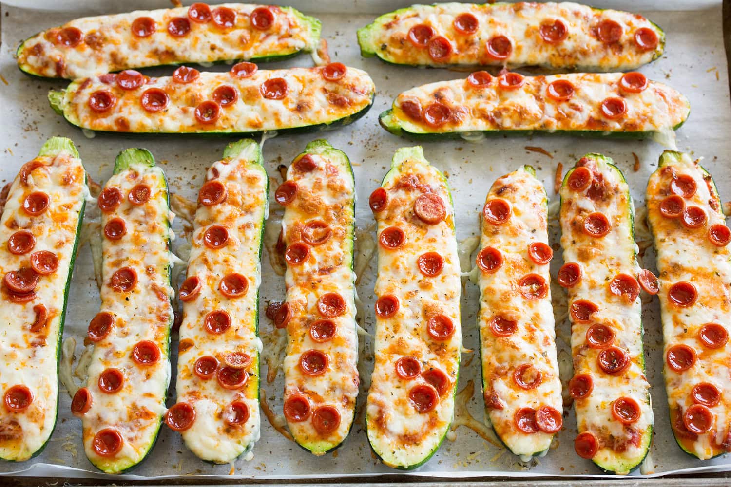 Completed zucchini pizza boats shown after baking through and completed.