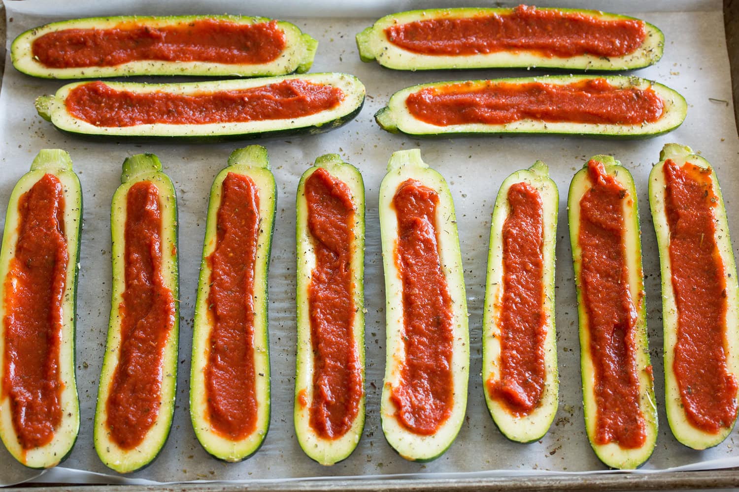 Zucchini portions with a pizza sauce filled center.